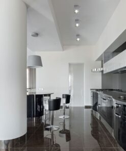 Μοντέρνα κουζίνα με γυαλιστερό μαύρο φινίρισμα και νησίδα με μαύρα ψηλά σκαμπό, ιδανική για σύγχρονα σπίτια.